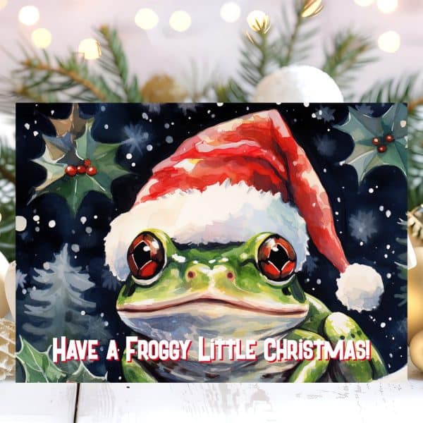 A Watercolor Painting Of A Frog Wearing A Santa Hat. The Frog Is The Central Focus, And The Background Features A Snowy Christmas Scene. Text Below Reads Have A Froggy Little Christmas!
