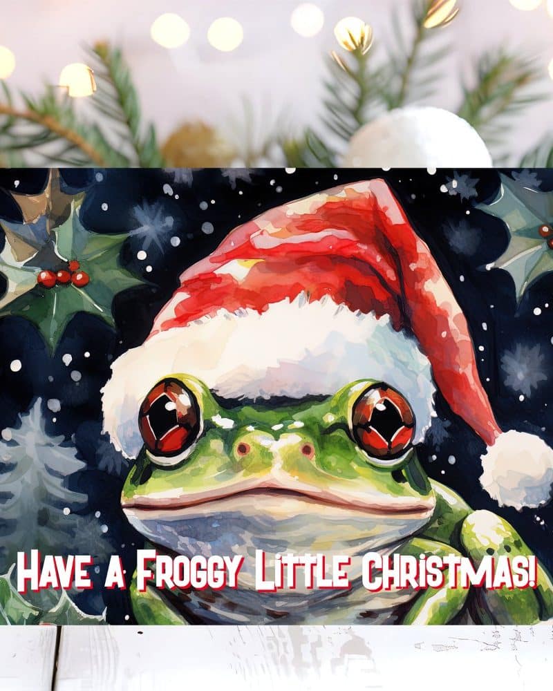 A watercolor painting of a frog wearing a Santa hat. The frog is the central focus, and the background features a snowy Christmas scene. Text below reads Have a Froggy Little Christmas!