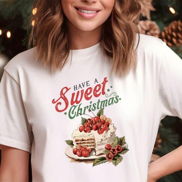 White T-Shirt With A Christmas Cake Design And The Text Have A Sweet Christmas.