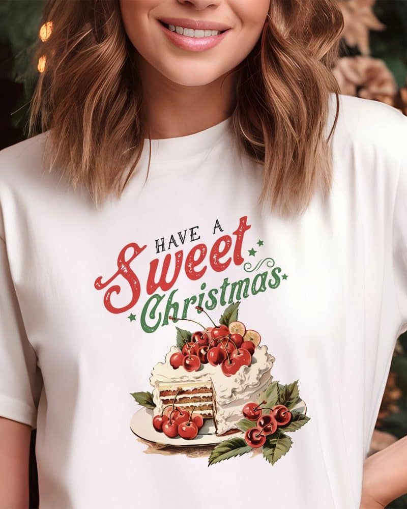White t-shirt with a Christmas cake design and the text Have a Sweet Christmas.