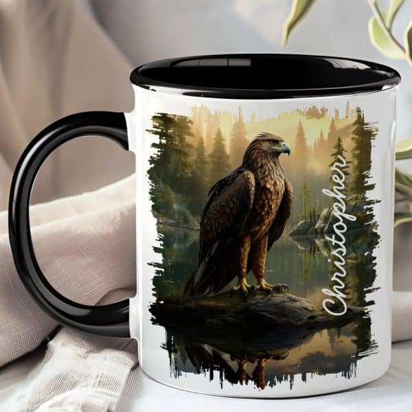 Black-Handled Mug With A Personalized Design Featuring An Eagle Perched On A Rock By A Lake In A Forest.
