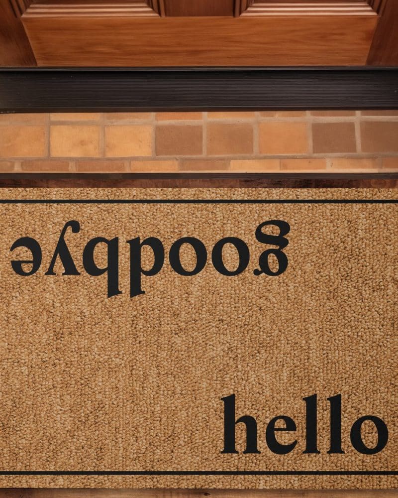 Tan doormat with the word hello and a backwards spelling of hello.