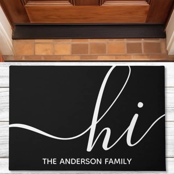 Black Welcome Mat With White Script Lettering That Says Hi And The Anderson Family Below.