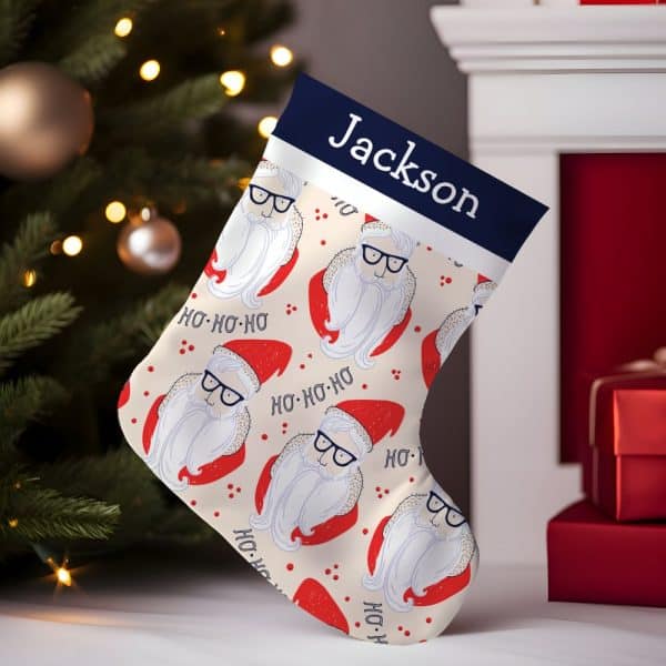 Personalized Christmas Stocking With A Cream Background Featuring A Repeating Pattern Of Hip Santa Clauses Wearing Glasses And The Name Jackson At The Top.