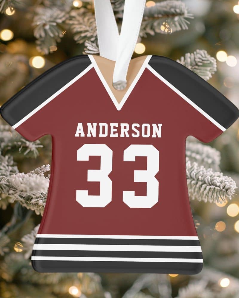 Burgundy and black personalized jersey-shaped Christmas ornament with the name Anderson and number 33.