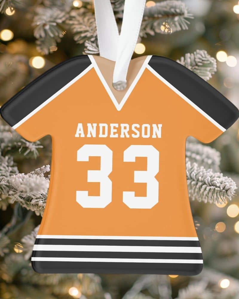 Orange and black jersey-shaped Christmas ornament with the name Anderson and number 33.