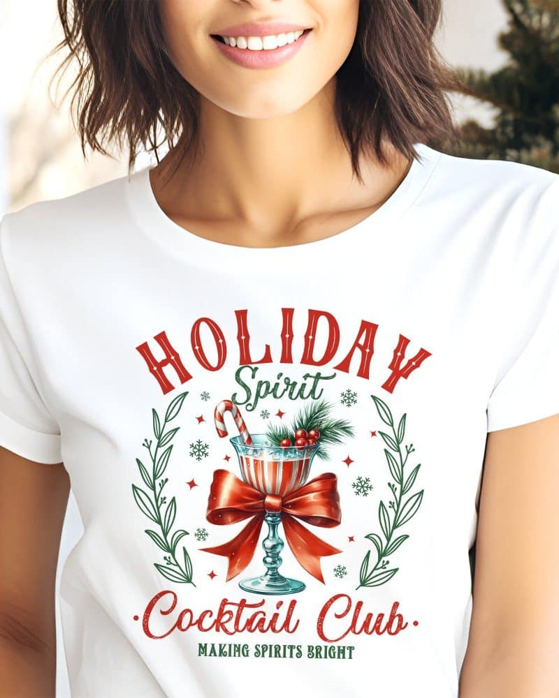 White t-shirt with a Christmas cocktail design, text reads Holiday Spirit Cocktail Club.