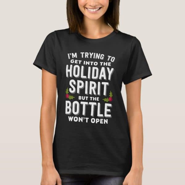 Woman Wearing A Black T-Shirt With A Humorous Christmas-Themed Message About Holiday Spirits.