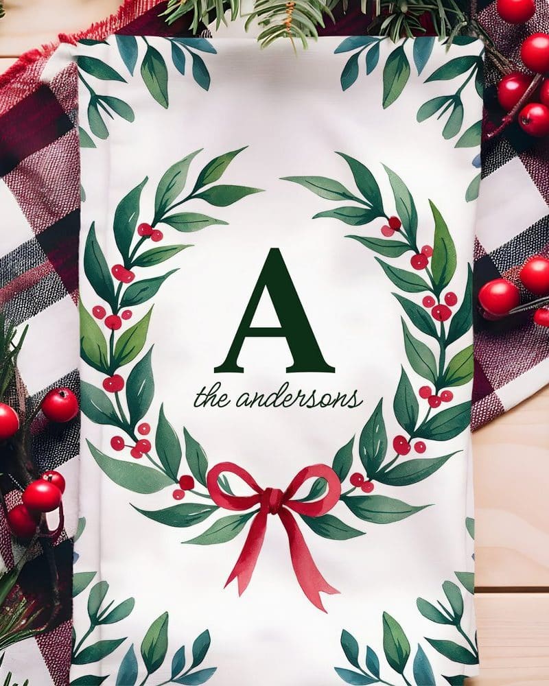Christmas tea towel featuring a monogrammed wreath.
