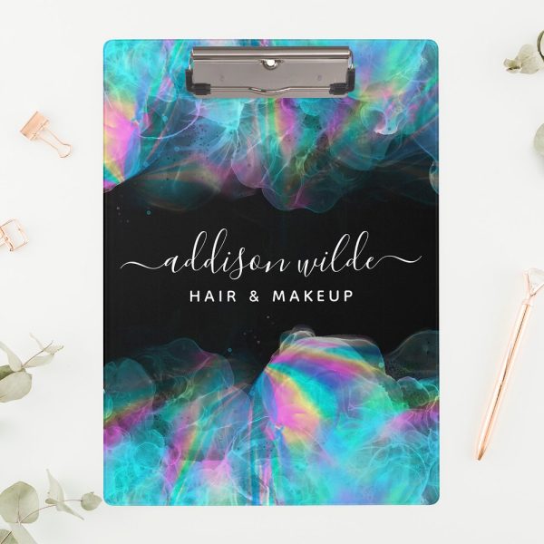 A Clipboard With A Black Background And Iridescent Teal And Pink Abstract Design. The Name Addison Wilde Hair &Amp; Makeup Is Displayed In A White Script Font.