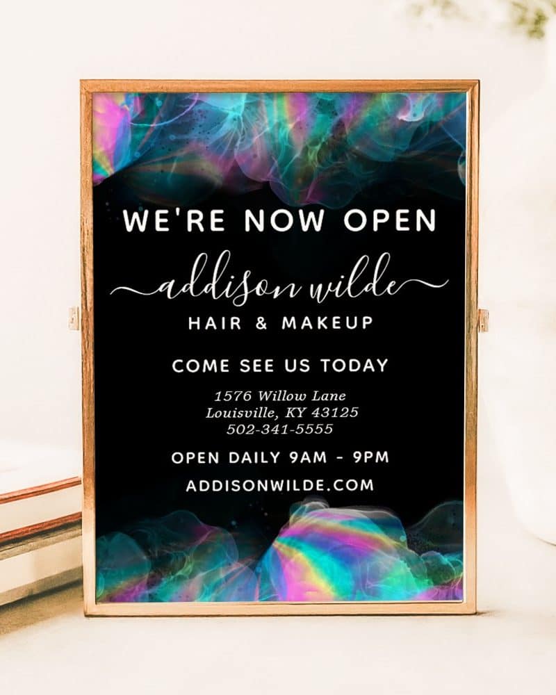 Grand opening sign for Addison Wilde Hair & Makeup, displaying the business name, address, phone number, and hours.