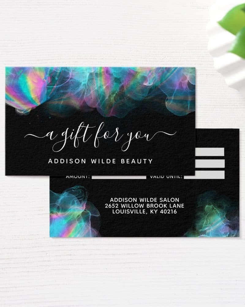 Black gift certificate with iridescent teal, pink, and purple abstract design; text says "a gift for you" and includes business information.