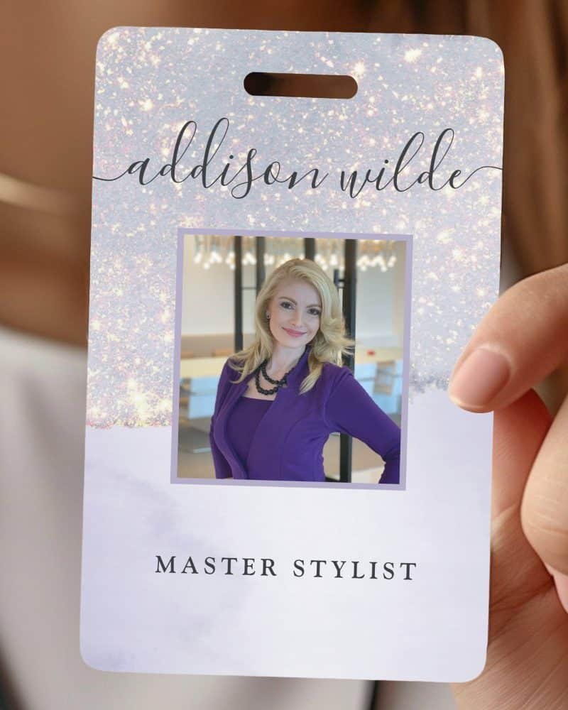 A light purple and silver glitter ID card for Addison Wilde, Master Stylist. A photo of the stylist is in the center.