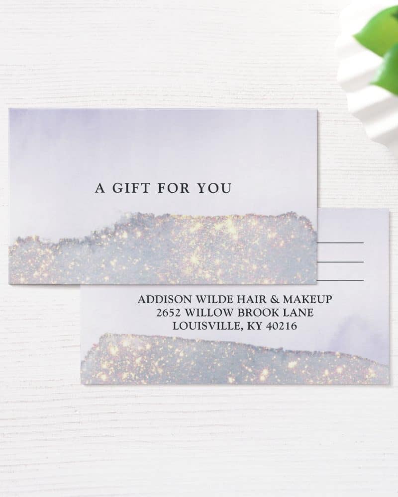 A lavender gift certificate with gold glitter accents from Addison Wilde Hair & Makeup.