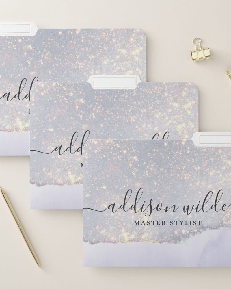 Three file folders with a sparkly lavender design. The bottom folder is labeled Addison Wilde, Master Stylist.