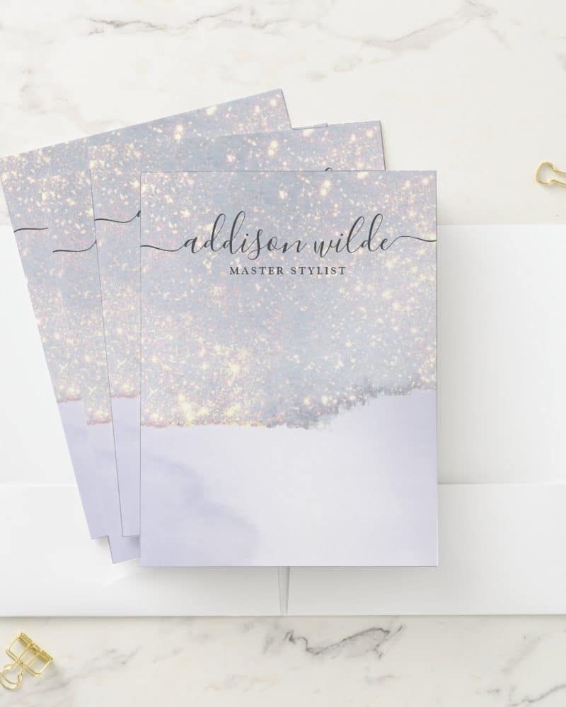 Stack of light purple, glitter-design business cards for Addison Wilde, Master Stylist.