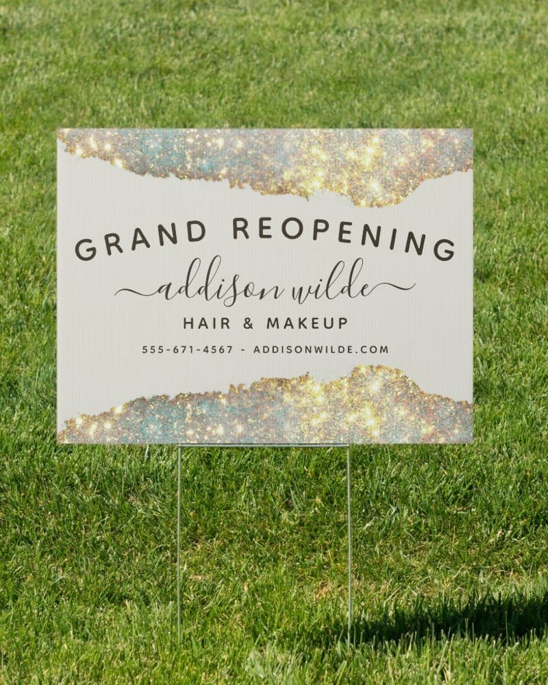 Grand reopening sign for Addison Wilde Hair & Makeup. The sign features a sparkly design.