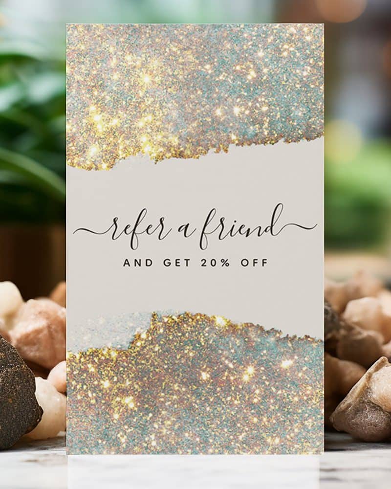 Refer a friend and get 20% off, a sparkly gold and teal promotional card.