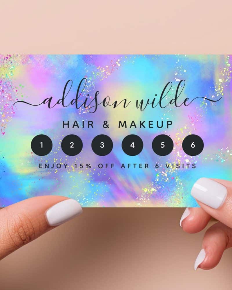 A pastel rainbow loyalty card for Addison Wilde Hair & Makeup, featuring six spaces to be punched. After six visits, 15% off is offered.