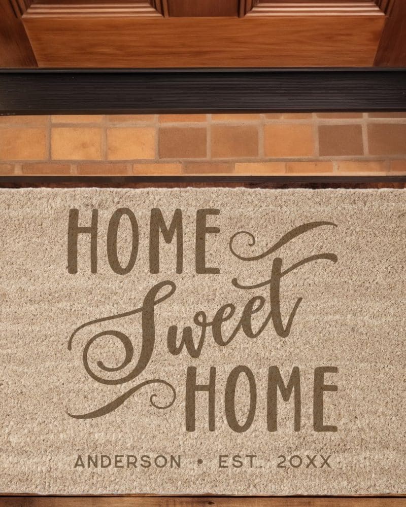 Tan doormat with the text Home Sweet Home in a stylized font, and Anderson Est. 20XX below.