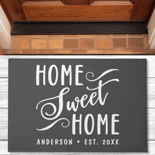Dark Gray Welcome Mat With White Script Lettering That Says Home Sweet Home And The Anderson Family Name And Establishment Year.