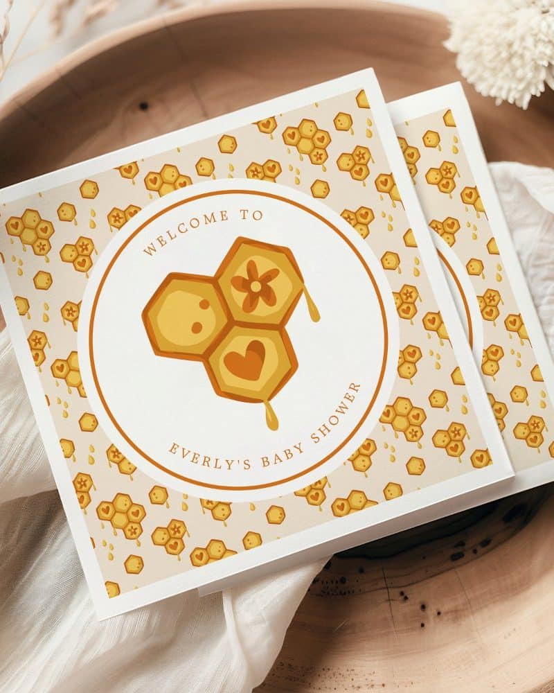 Baby shower invitation with a honeycomb design.