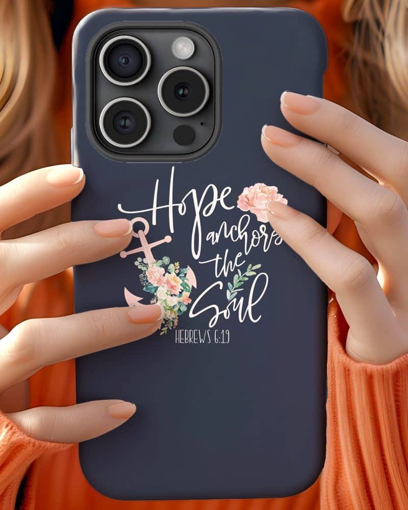 A dark blue phone case featuring a floral anchor design and the text Hope anchors the soul, Hebrews 6:19.