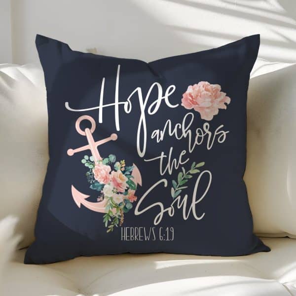 Navy Blue Throw Pillow With The Phrase Hope Anchors The Soul And A Pink Anchor With Flowers. Hebrews 6:19 Is Also Displayed.