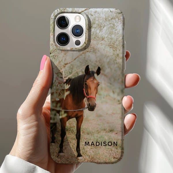 A Hand Holding An Iphone Case Featuring A Brown Horse In A Field. The Name Madison Is Printed On The Case.