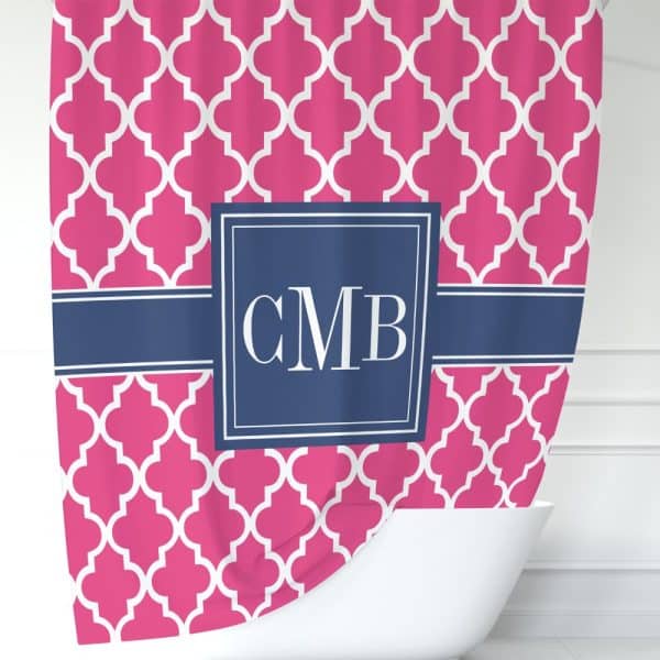 Pink Shower Curtain With A Navy Blue Monogram And Quatrefoil Pattern.