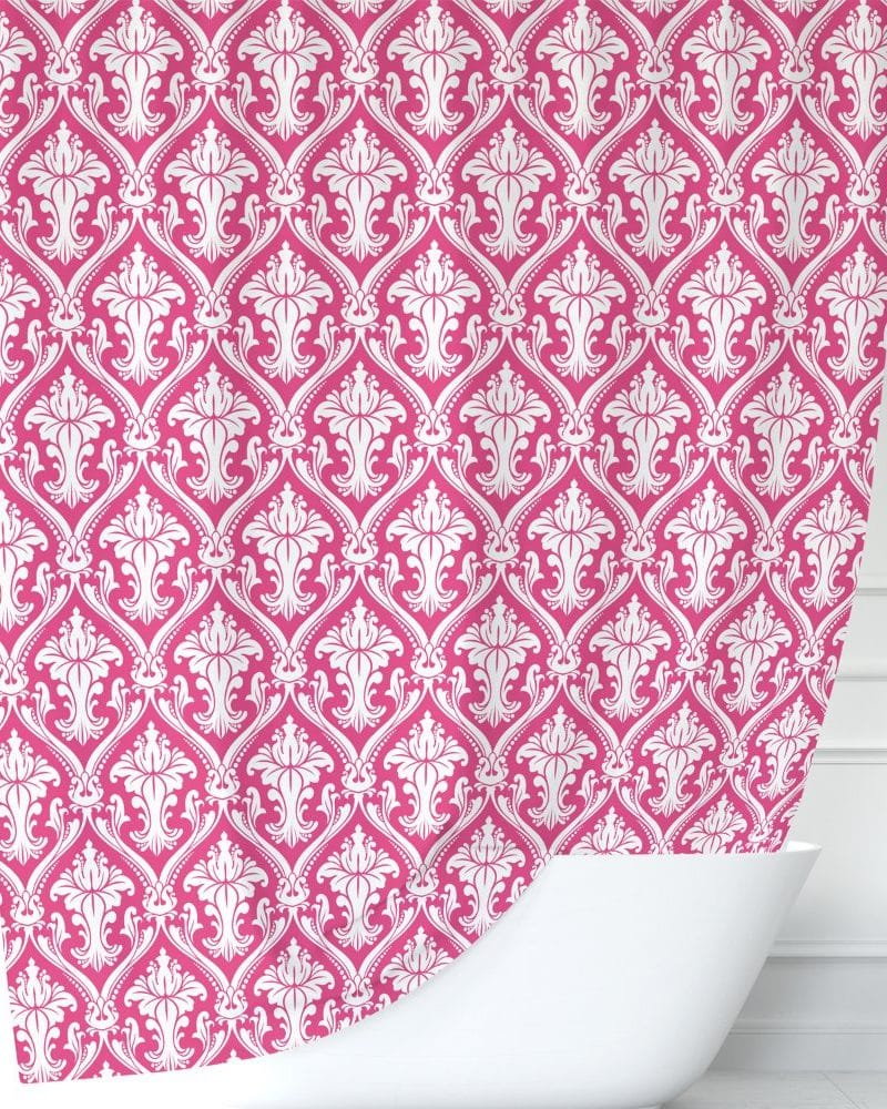 Pink shower curtain with a white damask pattern.