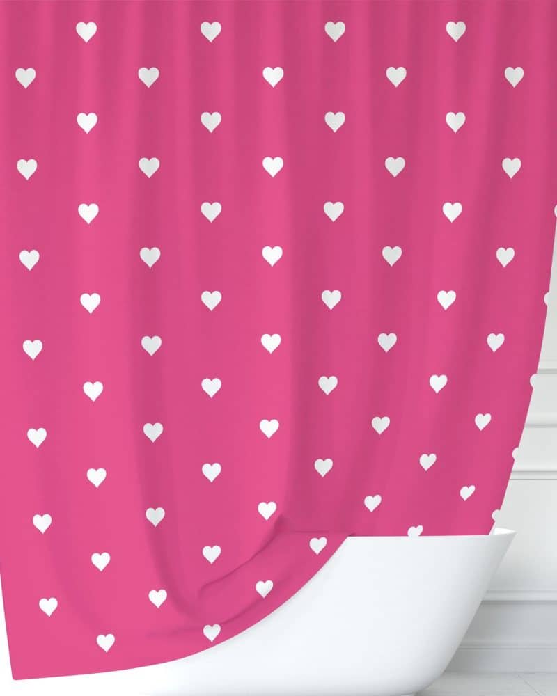 Pink shower curtain with a white heart pattern.