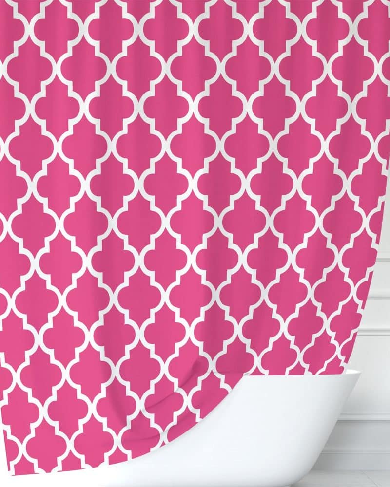 Pink shower curtain with a white quatrefoil pattern.