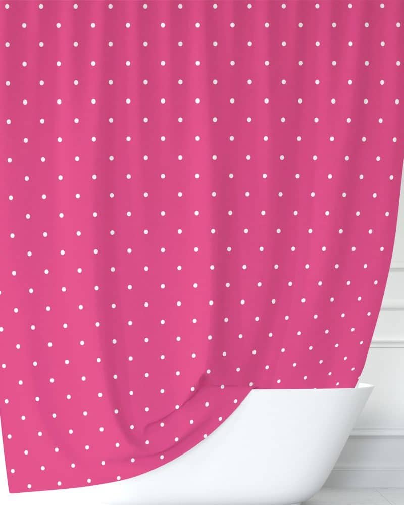 Pink shower curtain with white polka dots.