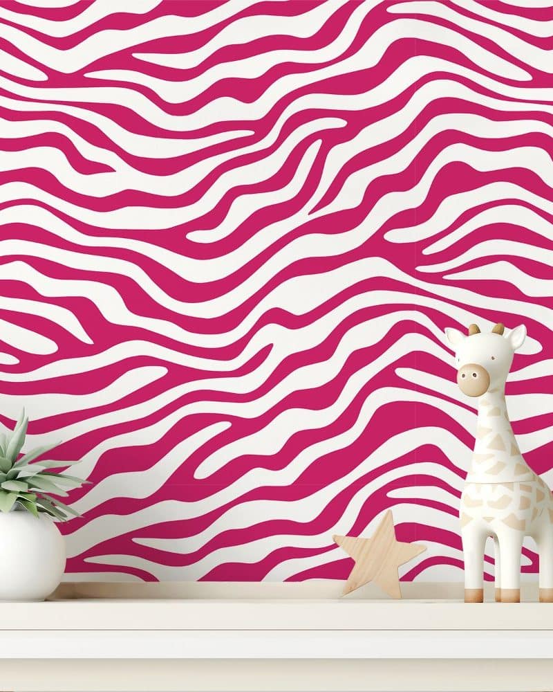 Pink and white zebra striped wall with a small giraffe figurine and a succulent plant.