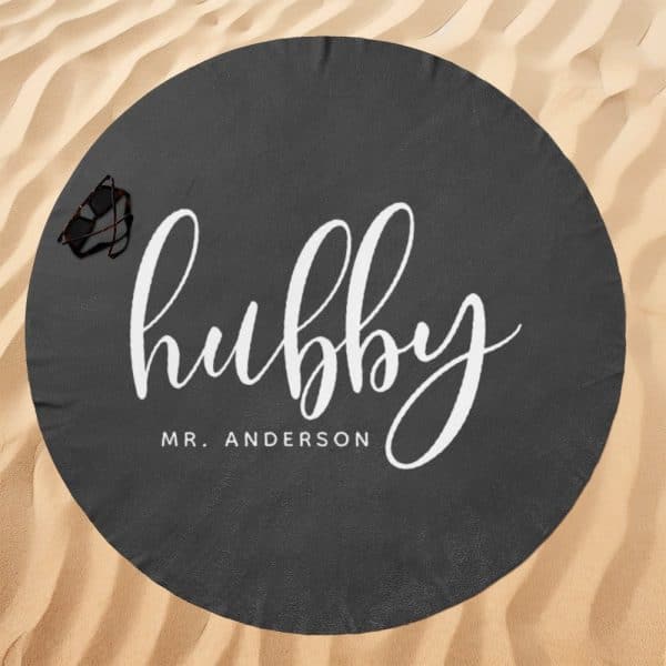 Dark Gray Round Beach Towel With The Word Hubby In White Script And Mr. Anderson Below It.
