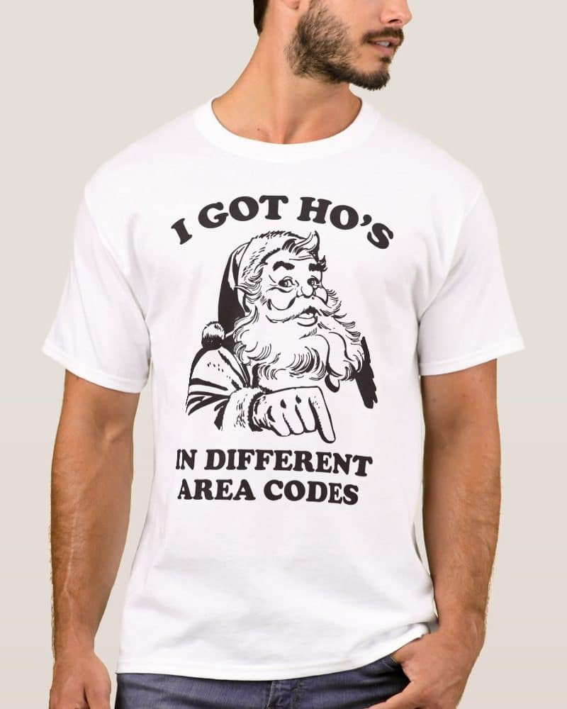 White t-shirt with a black and white illustration of Santa Claus pointing down; text reads I got ho's in different area codes.