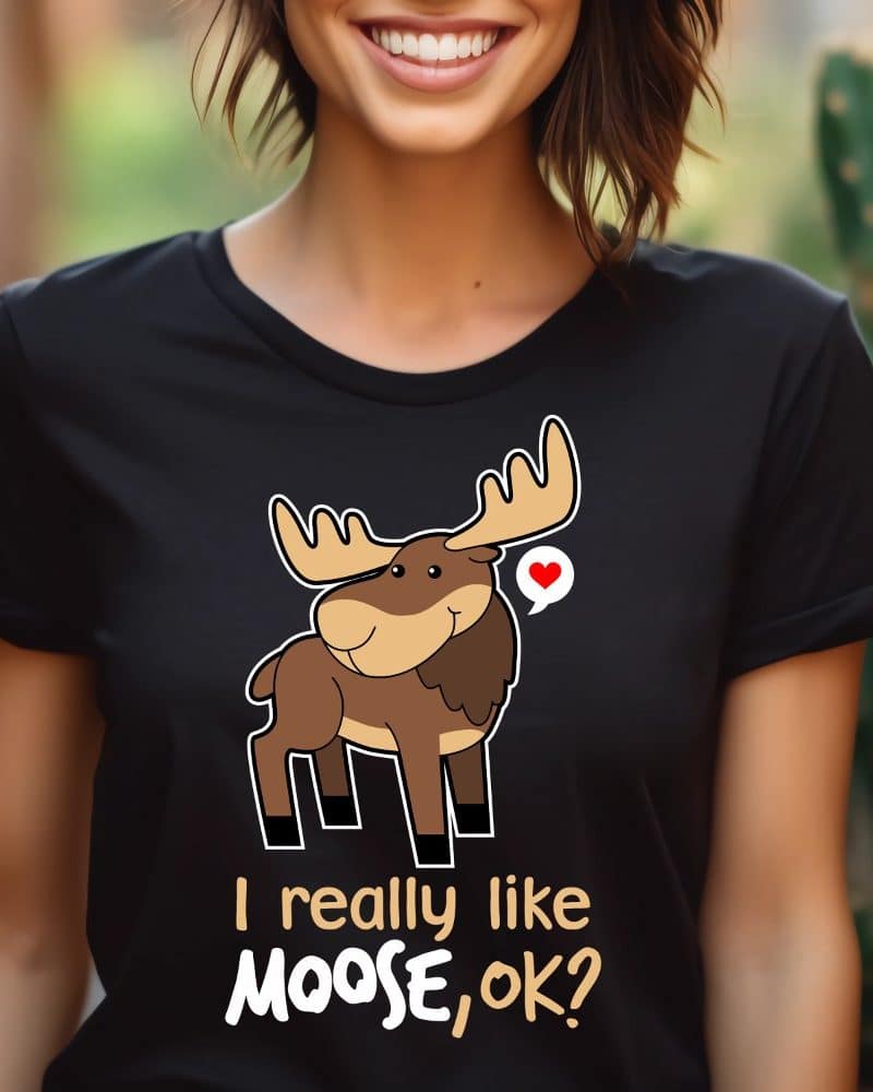 Woman wearing a black t-shirt featuring a cartoon moose and the text I really like Moose, ok?