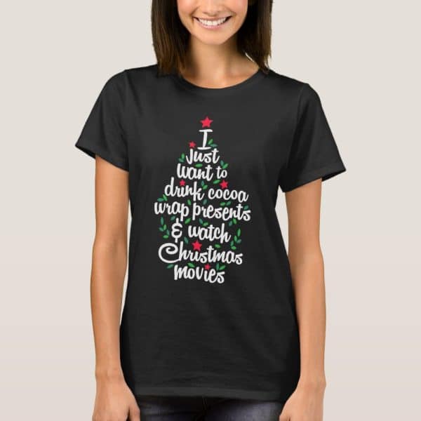 Woman Wearing A Black T-Shirt With A Christmas Tree Design. The Tree Is Made Of Text That Says I Just Want To Drink Cocoa, Wrap Presents &Amp; Watch Christmas Movies.