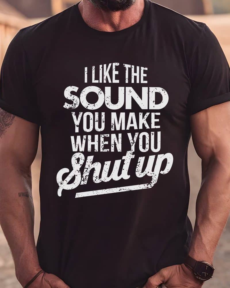 A man wearing a black t-shirt with white text that says, I like the sound you make when you shut up.