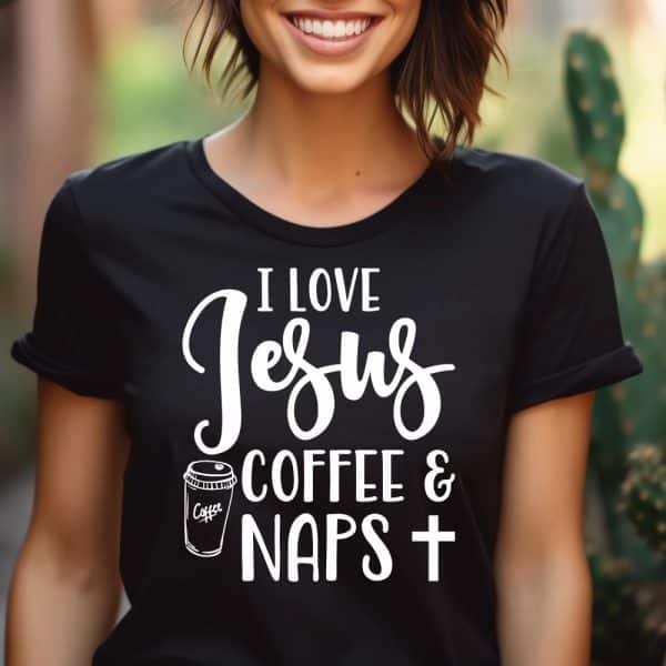 Woman Wearing A Black T-Shirt With White Lettering That Says I Love Jesus, Coffee And Naps, Plus A Cross Symbol.