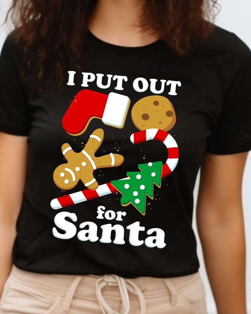 Black t-shirt with a Christmas design featuring cookies, a candy cane, and the text I put out for Santa.