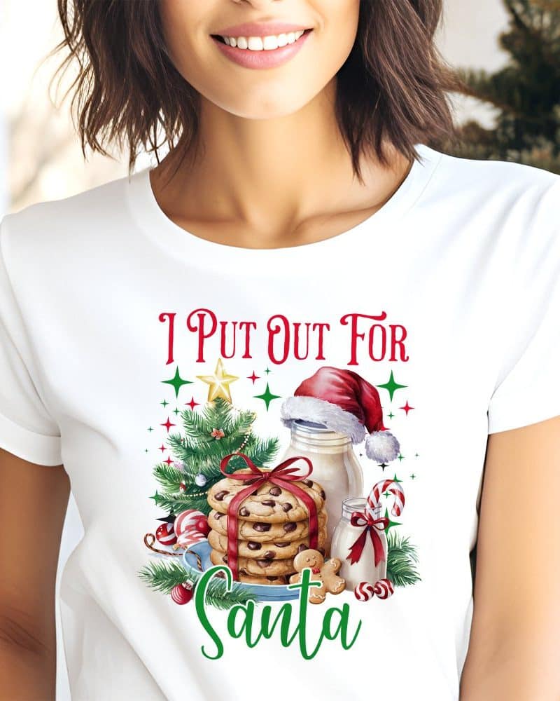 White t-shirt with a Christmas design featuring cookies, milk, and a Santa hat.