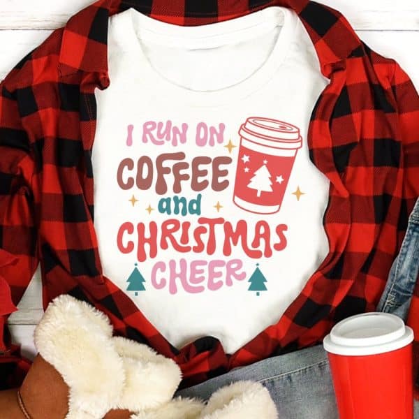White T-Shirt With The Text I Run On Coffee And Christmas Cheer And A Coffee Cup Graphic.