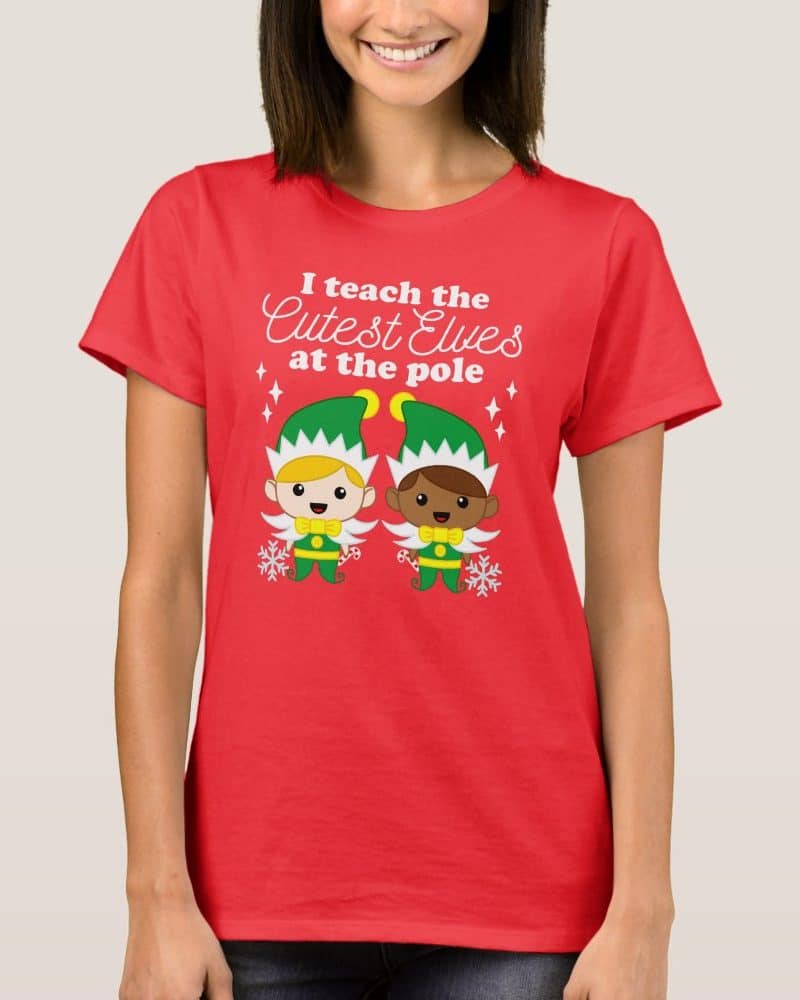 Red t-shirt featuring two cartoon elves and the text: I teach the cutest elves at the pole.