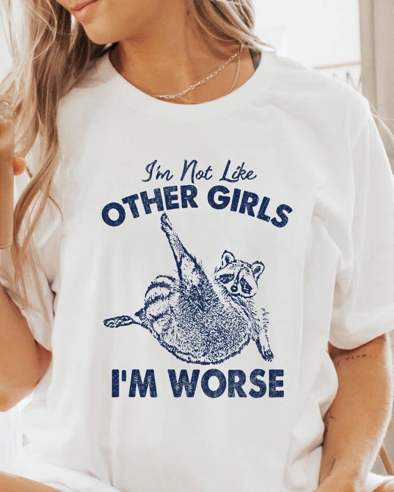 White t-shirt featuring a raccoon graphic and the text Im Not Like Other Girls Im Worse.