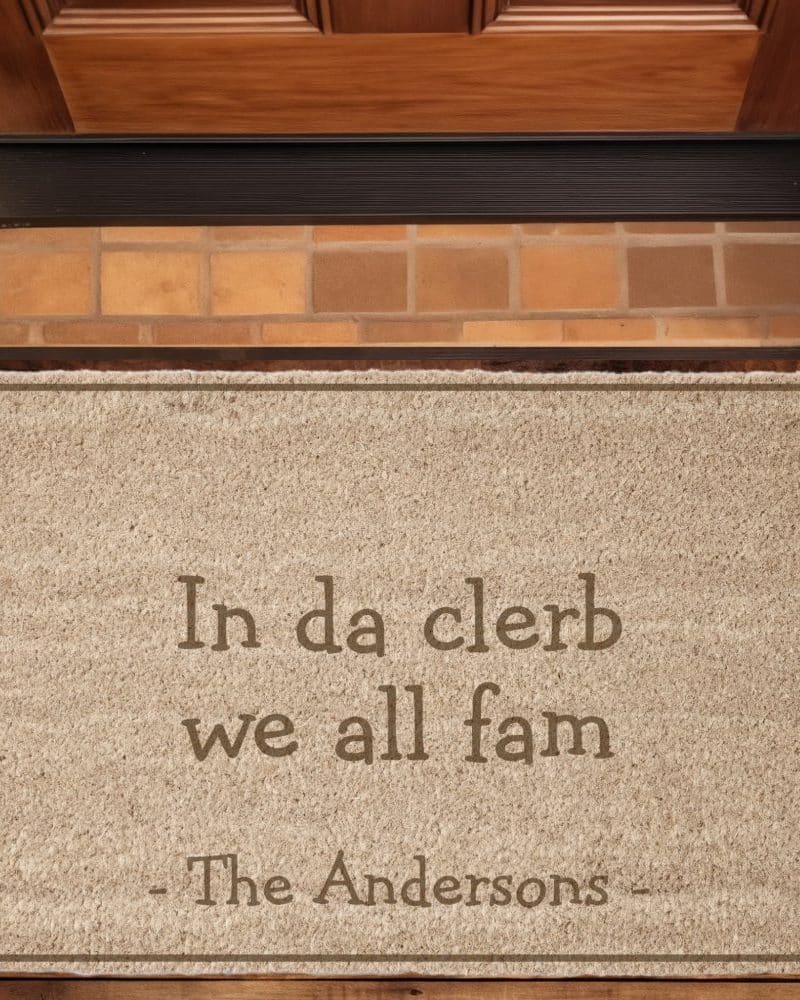 Beige welcome mat with the text In da clerb we all fam, The Andersons.