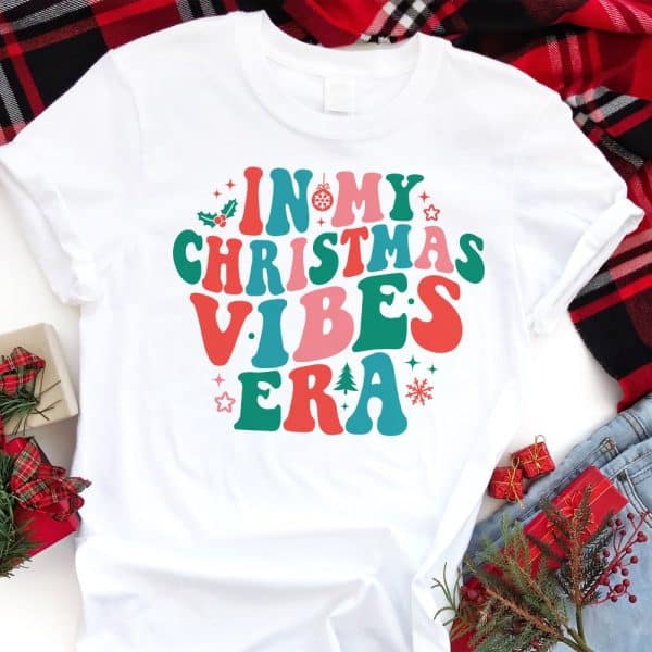 White T-Shirt With Colorful Retro-Style Text Reading In My Christmas Vibes Era.