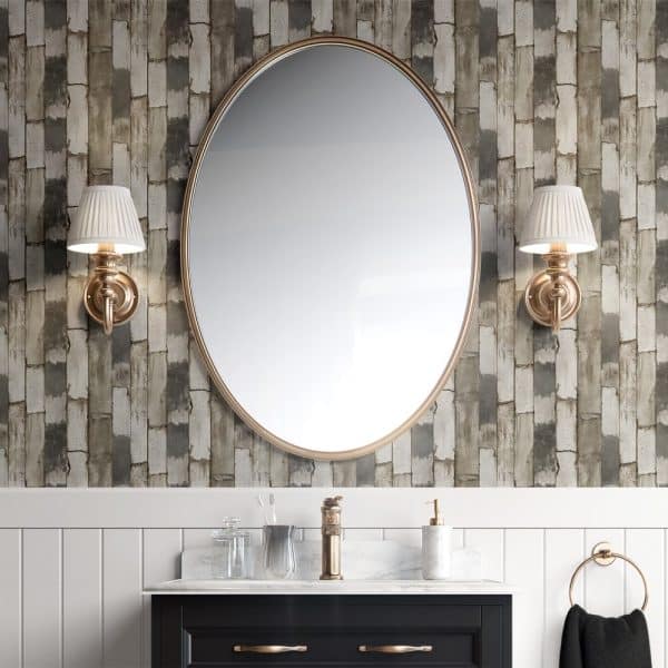 Large Oval Mirror Above A Bathroom Vanity With Gray And Beige Brick Wallpaper.