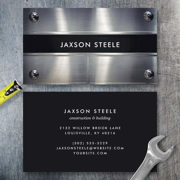 Two Business Cards For Jaxson Steele Construction And Building. The Top Card Features A Brushed Metal Design; The Bottom Card Is Black With White Text.